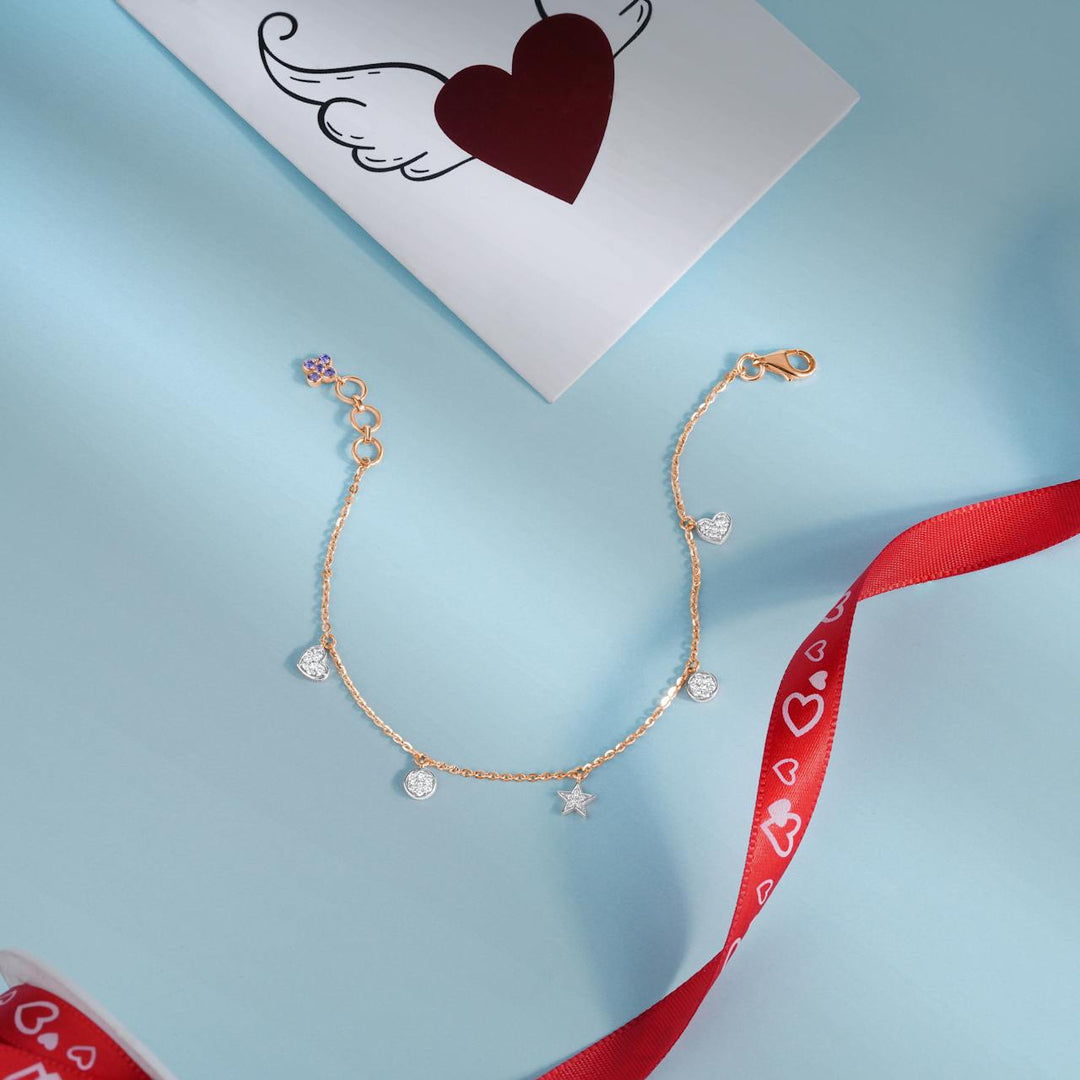 Close-up of sparkling jewelry: heart-shaped pendant, charm bracelet, diamond earrings, and gemstone rings on a soft, warm-lit background.
